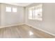 A light and airy room featuring vinyl floors, base trim, natural light, and neutral paint at 27534 E Byers Ave, Aurora, CO 80018