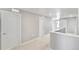 Bright hallway features neutral walls and plush carpeting, complemented by white doors and trim at 27534 E Byers Ave, Aurora, CO 80018
