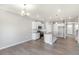 Kitchen offers modern white cabinetry, stainless appliances, and an island at 27534 E Byers Ave, Aurora, CO 80018