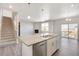 Spacious kitchen island overlooks an open floor plan with fireplace and outdoor patio access at 27534 E Byers Ave, Aurora, CO 80018