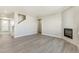 Open-concept living area boasts stairs, a fireplace, and wood-style floors at 27534 E Byers Ave, Aurora, CO 80018