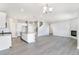 Open-concept living space with hardwood floors, modern lighting, and seamless flow to other rooms at 27534 E Byers Ave, Aurora, CO 80018