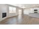 Bright, open living area featuring hardwood floors, modern lighting, and a fireplace at 27534 E Byers Ave, Aurora, CO 80018