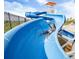 Thrilling waterslide experience with a person sliding down into the sparkling water at 27534 E Byers Ave, Aurora, CO 80018