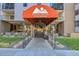 Condominium entrance with awning, landscaping, and pathway at 2 Adams St # 901, Denver, CO 80206