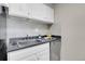 Kitchen with white cabinets, stainless steel sink, and ample counter space at 2 Adams St # 901, Denver, CO 80206