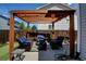 Inviting backyard patio with pergola, string lights, and comfortable seating for outdoor relaxation at 3769 Dahlia St, Denver, CO 80207