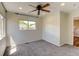 Bedroom with light walls, carpet flooring, large window, and ceiling fan at 3769 Dahlia St, Denver, CO 80207