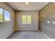 Bright bedroom with carpet floors, wooden accent wall, and lots of light at 3769 Dahlia St, Denver, CO 80207