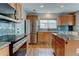 Modern kitchen featuring stainless steel appliances, granite countertops, and a center island with seating at 3769 Dahlia St, Denver, CO 80207