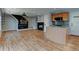 Spacious living room featuring hardwood floors, a cozy fireplace, and a view of the adjacent kitchen area at 3769 Dahlia St, Denver, CO 80207