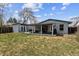 Spacious backyard showcasing a covered patio, garden area, and expansive lawn, perfect for outdoor enjoyment at 794 S Ivy St, Denver, CO 80224