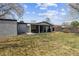 A well-manicured backyard featuring a covered patio, lush lawn, and ample space for outdoor activities at 794 S Ivy St, Denver, CO 80224