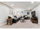 A cozy finished basement features comfortable seating, neutral carpet, and modern fixtures for a relaxing atmosphere at 794 S Ivy St, Denver, CO 80224