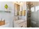 This renovated bathroom boasts a glass shower, and modern fixtures, creating a spa-like atmosphere with lots of natural light at 794 S Ivy St, Denver, CO 80224