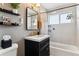 This renovated bathroom boasts a glass shower and modern fixtures, creating a spa-like atmosphere with lots of natural light at 794 S Ivy St, Denver, CO 80224