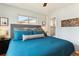 A cozy bedroom featuring a large window, ceiling fan, wood floors, and decor to give this room a peaceful ambience at 794 S Ivy St, Denver, CO 80224