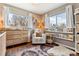 A sun-lit Bedroom features warm natural light, wood floors, and an accent rug to create a soft and cozy atmosphere at 794 S Ivy St, Denver, CO 80224