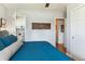 A cozy bedroom featuring a large window, ceiling fan, wood floors, and decor to give this room a peaceful ambience at 794 S Ivy St, Denver, CO 80224