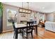 Bright dining area with natural light, modern light fixture, and views to the backyard at 794 S Ivy St, Denver, CO 80224