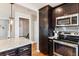 An updated kitchen boasting stainless steel appliances, wood floors, a subway tile backsplash, and white and grey granite countertops at 794 S Ivy St, Denver, CO 80224