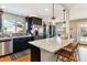 Bright kitchen with a spacious island, stainless steel appliances, and dark wood cabinetry at 794 S Ivy St, Denver, CO 80224