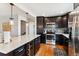 Updated kitchen with stainless steel appliances, granite countertops, and a spacious center island at 794 S Ivy St, Denver, CO 80224
