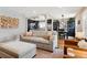 Bright and airy living room open to dining room features hardwood floors, modern furnishings, and a welcoming ambiance at 794 S Ivy St, Denver, CO 80224