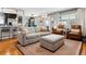 Cozy living room featuring hardwood floors, modern furniture, and a bright, open layout perfect for relaxing and entertaining at 794 S Ivy St, Denver, CO 80224