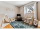 This playroom features a large window, wood floors, and decorative fixtures to create a playful and cozy space at 794 S Ivy St, Denver, CO 80224