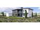 Two-story home with a balcony, neutral siding, dark trim, manicured lawn, mature trees, and flowerbeds at 5032 Nile Ct, Golden, CO 80403