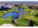 Community aerial view showcasing the well-maintained golf course with sand traps, water feature, and walking paths at 725 S Clinton St # 1B, Denver, CO 80247