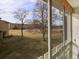View from the balcony overlooking a landscaped green space with trees and nearby buildings at 725 S Clinton St # 1B, Denver, CO 80247