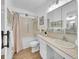 Bright bathroom with a shower-tub, vanity, modern lighting, and decorative art at 725 S Clinton St # 1B, Denver, CO 80247