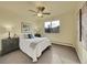 Cozy bedroom with neutral tones, plush carpet, a ceiling fan, and a sunlit window at 725 S Clinton St # 1B, Denver, CO 80247