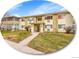 A two-story apartment complex featuring well-kept landscaping, a charming walkway, and a welcoming facade at 725 S Clinton St # 1B, Denver, CO 80247