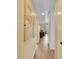 Inviting hallway featuring smooth, well-maintained floors, leading to a bright living space with a sliding door at 725 S Clinton St # 1B, Denver, CO 80247