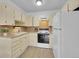 Bright kitchen boasts white appliances, ample counter space, and is ready for new owners to add their personal touches at 725 S Clinton St # 1B, Denver, CO 80247