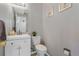Well-lit powder room boasts charming decor and a white vanity at 1379 S Idalia St # C, Aurora, CO 80017