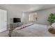 Bright bedroom with soft carpet, TV area, and a neutral palette creates a relaxing and inviting atmosphere at 1379 S Idalia St # C, Aurora, CO 80017