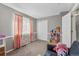 Charming bedroom features neutral tones and an abundance of natural light from a window with stylish pink curtains at 1379 S Idalia St # C, Aurora, CO 80017