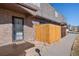 Charming brick townhome entrance with a decorative security door and wooden fence at 1379 S Idalia St # C, Aurora, CO 80017