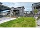 Spacious backyard with lush green grass, a wooden fence, and a patio at 6950 Hidden Cove Ct, Castle Pines, CO 80108