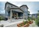 Charming home featuring a covered patio, garden beds, and low-maintenance landscaping at 6950 Hidden Cove Ct, Castle Pines, CO 80108
