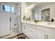 Bathroom featuring double vanity with modern fixtures and glass enclosed shower at 6950 Hidden Cove Ct, Castle Pines, CO 80108