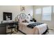 Well-lit bedroom with a desk, chair, and ample natural light at 6950 Hidden Cove Ct, Castle Pines, CO 80108