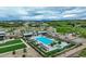 Community pool area with lounge chairs, a pavilion, and beautiful landscaping at 6950 Hidden Cove Ct, Castle Pines, CO 80108