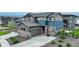 Beautiful two-story home featuring a three-car garage and landscaped front yard at 6950 Hidden Cove Ct, Castle Pines, CO 80108