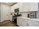 Bright kitchen with stainless steel appliances, white cabinets, and light countertops at 6950 Hidden Cove Ct, Castle Pines, CO 80108