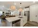 Open kitchen featuring stainless appliances, an island with bar stool seating, and hardwood floors at 6950 Hidden Cove Ct, Castle Pines, CO 80108